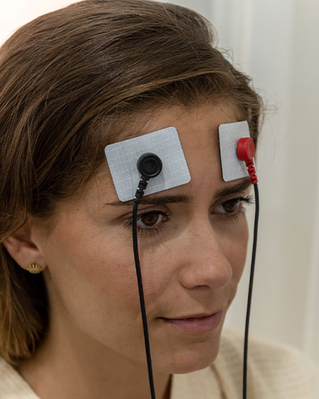 Woman with electrodes connected to her forehead