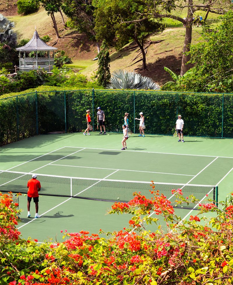 group of people receiving tennis instruction